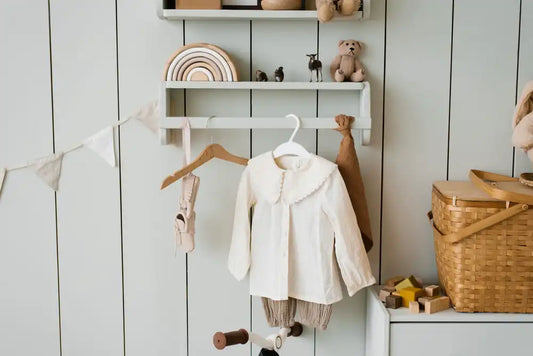 Vêtements bébé faits main suspendus dans une chambre cocon et chaleureuse