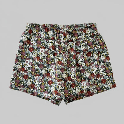 Jupe-culotte bébé fille vue de dos, imprimé Liberty fleuri multicolore sur fond marine, taille élastique