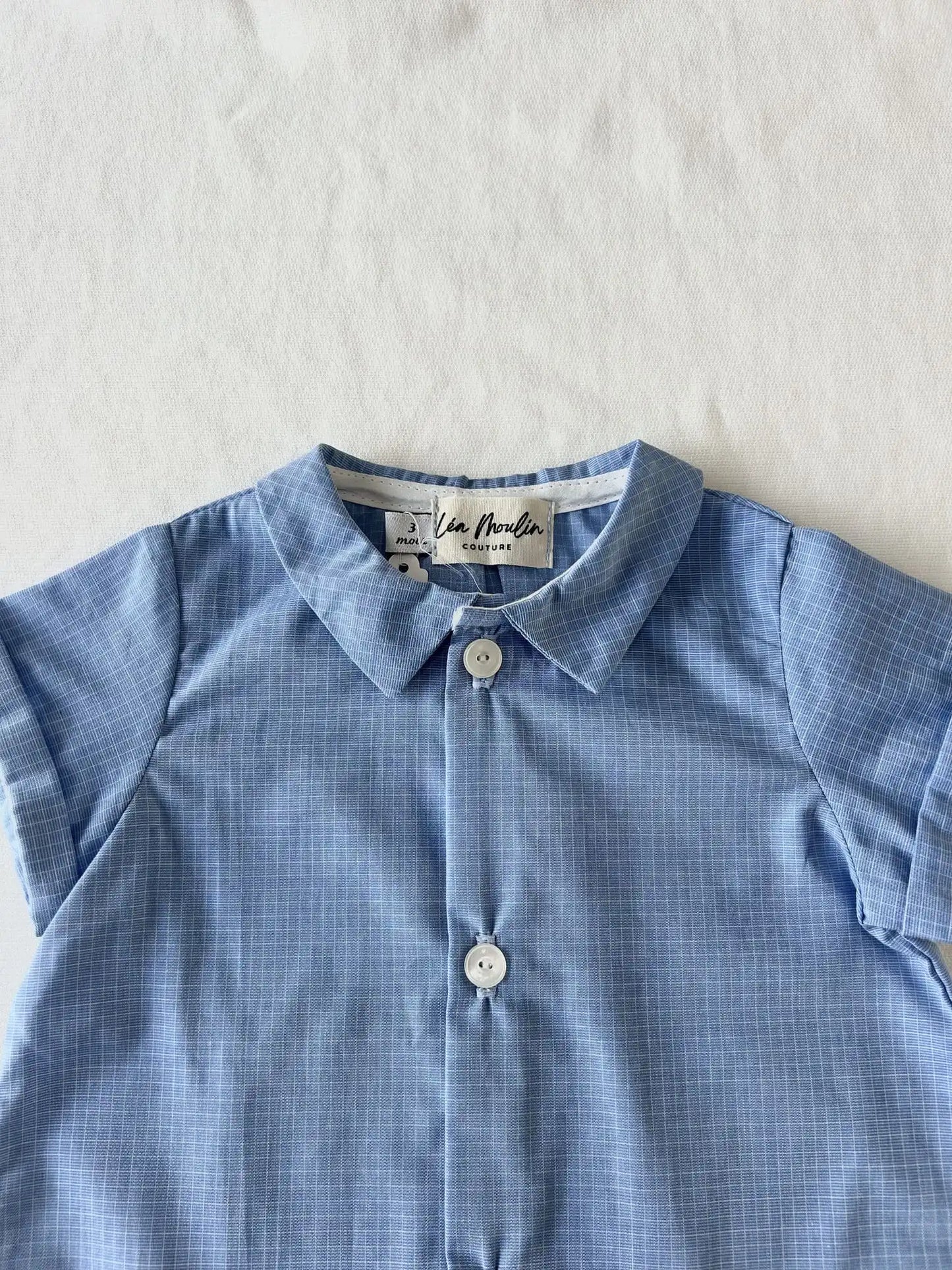 Détail col et coton naturel sur barboteuse bébé mixte artisanale.